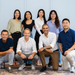 FEBE Ventures' team standing against a blue wall