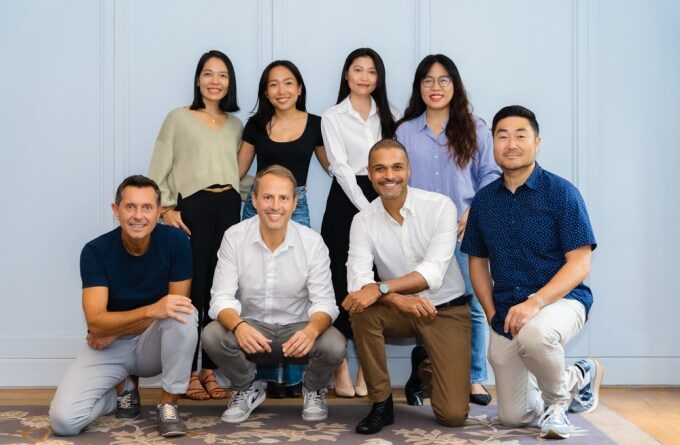 FEBE Ventures' team standing against a blue wall